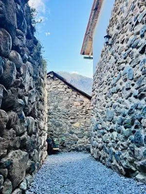 an alley in a stone building with a stone wall at Stone house in Ollantaytambo in Ollantaytambo