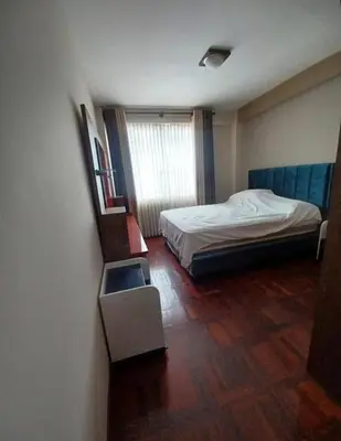 a small bedroom with a bed and a window at los hirukus cusco in Cusco