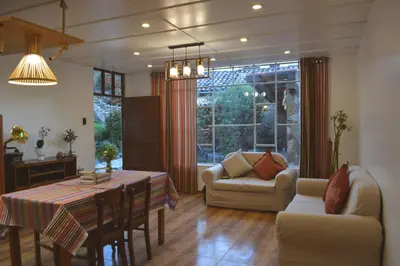 a living room with a table and a dining room at La Casa de Toño in Huancayo