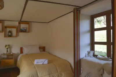 a bedroom with a bed and a window at La Casa de Toño in Huancayo