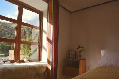 a bedroom with a window with a view of a mountain at La Casa de Toño in Huancayo