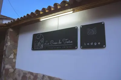 two signs on the side of a building at La Casa de Toño in Huancayo