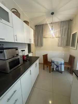 a kitchen with white cabinets and a microwave at Comfortable apartment in downtown area - 3 bedrooms in Lima