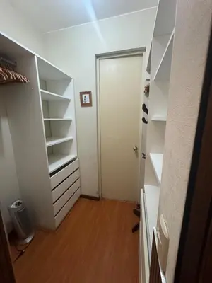 a walk in closet with a white door and shelves at Comfortable apartment in downtown area - 3 bedrooms in Lima