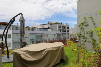 a patio with an umbrella and a building at Schell in Miraflores by Wynwood House in Lima