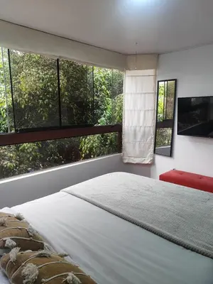 a bedroom with a large bed in front of a window at Céntrica habitación con vistas Larcomar in Lima