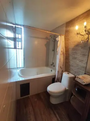 a bathroom with a tub and a toilet and a sink at Cómoda y céntrica habitación Larcomar in Lima