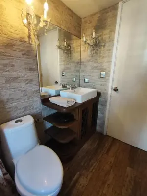 a bathroom with a toilet and a sink and a mirror at Cómoda y céntrica habitación Larcomar in Lima