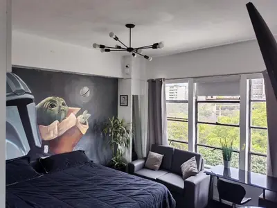 a bedroom with a star wars painting on the wall at PintoHome in Lima
