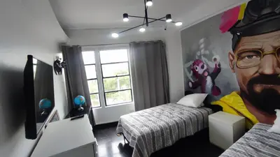 a bedroom with a large painting of a man at PintoHome in Lima