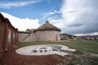 a building with a stone oven in a yard at Pachamama Hampina Wasi Ancestral Center in Urubamba