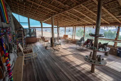 a large room with wooden floors and glass windows at Pachamama Hampina Wasi Ancestral Center in Urubamba