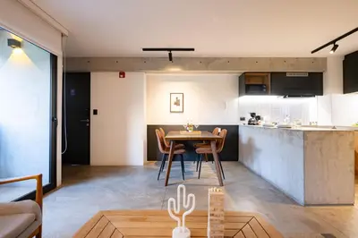 a kitchen and living room with a table and chairs at MMXX Apartments by Vibrant in Lima