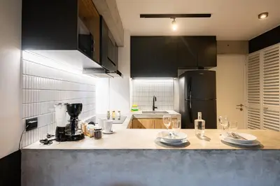 a kitchen with a counter with wine glasses on it at MMXX Apartments by Vibrant in Lima