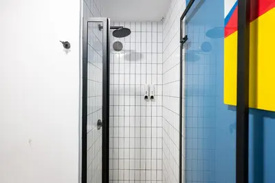 a shower with a glass door in a bathroom at MMXX Apartments by Vibrant in Lima