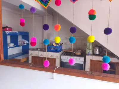 a toy kitchen with colorful balls hanging from the ceiling at El despertar del inka in Cusco