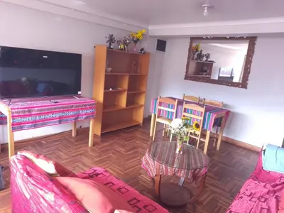 a living room with a couch and a table at El despertar del inka in Cusco