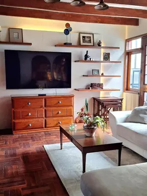 a living room with a large tv on a wall at Historic Quinta, Heart of Miraflores, 2 Bedroom Apartment in Lima