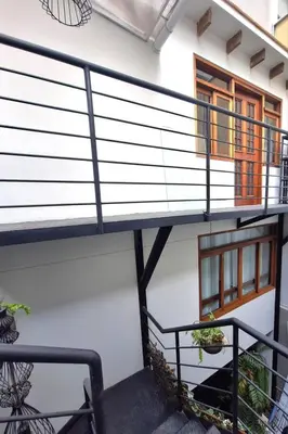 a staircase leading up to a house with a balcony at Historic Quinta, Heart of Miraflores, 2 Bedroom Apartment in Lima