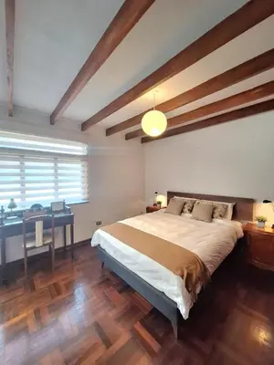 a bedroom with a large bed and a desk at Historic Quinta, Heart of Miraflores, 2 Bedroom Apartment in Lima