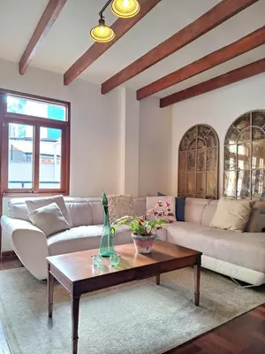 a living room with a couch and a coffee table at Historic Quinta, Heart of Miraflores, 2 Bedroom Apartment in Lima