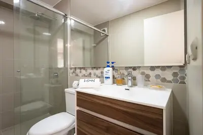 a bathroom with a toilet and a sink and a shower at Art&U Apartments by Vibrant in Lima