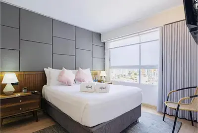 a bedroom with a large bed and a large window at Art&U Apartments by Vibrant in Lima
