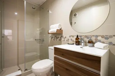 a bathroom with a toilet and a sink and a shower at Art&U Apartments by Vibrant in Lima