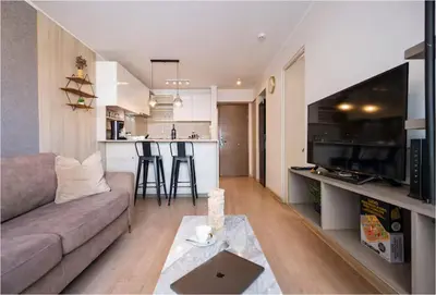 a living room and kitchen with a couch and a table at Art&U Apartments by Vibrant in Lima