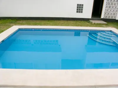 a swimming pool with blue water in a yard at Apartment with Beach Exit 201 in Punta Negra