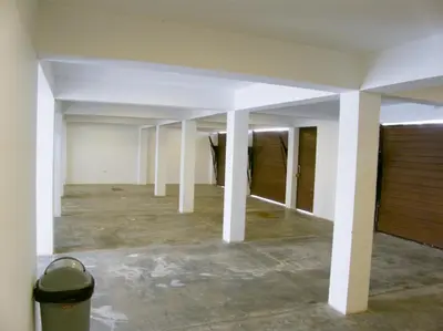 an empty room with white pillars in a building at Apartment with Beach Exit 201 in Punta Negra