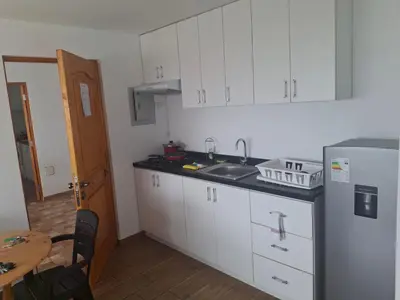 a kitchen with white cabinets and a sink and a refrigerator at Apartment with Beach Exit 201 in Punta Negra