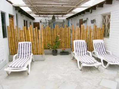 three chairs sitting on a patio next to a wooden fence at Apartment with Beach Exit 204 in Punta Negra