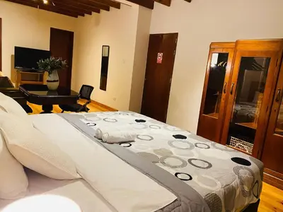 a bedroom with a large bed in a room at Apto/ cama king2 en el centro Miraflores in Lima