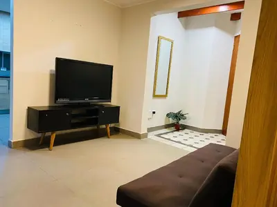 a living room with a flat screen tv at Tu Refugio en Miraflores – Céntrico y Tranquilo in Lima
