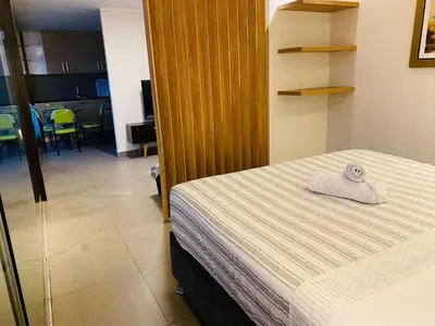 a bedroom with a bed with a towel on it at Tu Refugio en Miraflores – Céntrico y Tranquilo in Lima