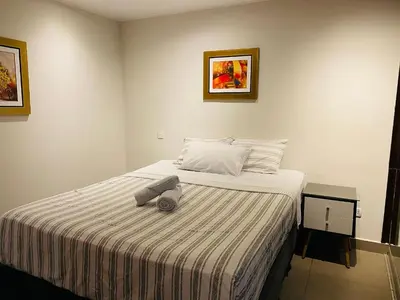 a bedroom with a bed with a towel on it at Tu Refugio en Miraflores – Céntrico y Tranquilo in Lima