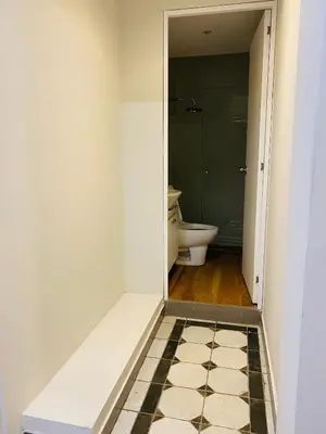an empty bathroom with a toilet and a doorway at Tu Refugio en Miraflores – Céntrico y Tranquilo in Lima