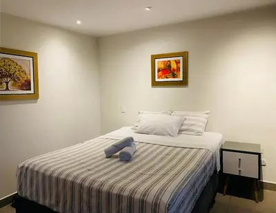 a bedroom with a bed with a blue towel on it at Tu Refugio en Miraflores – Céntrico y Tranquilo in Lima