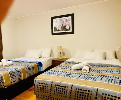 a room with two beds and a picture on the wall at Suite Independiente con Baño Privado – Miraflore in Lima
