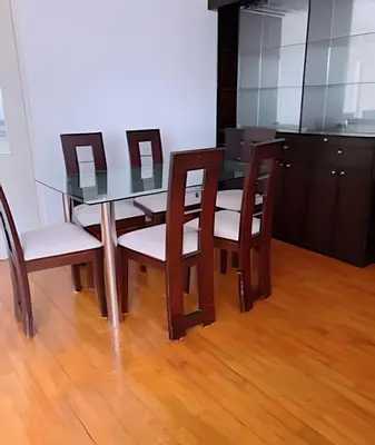 a dining room table with four chairs and a kitchen at SM3 Habitación pequeña con baño privado/Miraflores in Lima