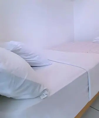 a white pillow sitting on top of a bed at SM3 Habitación pequeña con baño privado/Miraflores in Lima