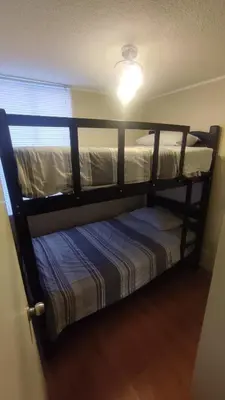 two bunk beds in a room with a window at Dpto entero 2 dormitorios 2 baños máximo 5 personas in Lima