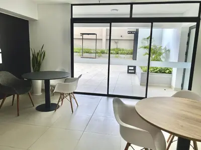 a room with tables and chairs and a patio at Apartamento con vista a San Isidro in Lima