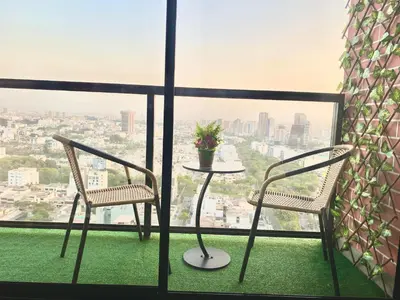 two chairs and a table in front of a window at Apartamento con vista a San Isidro in Lima