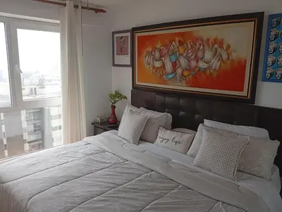 a bedroom with a large white bed with a large window at Large Oceanview Balcony Apartment in Miraflores in Lima