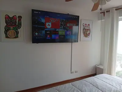 a bedroom with a flat screen tv on a wall at Large Oceanview Balcony Apartment in Miraflores in Lima
