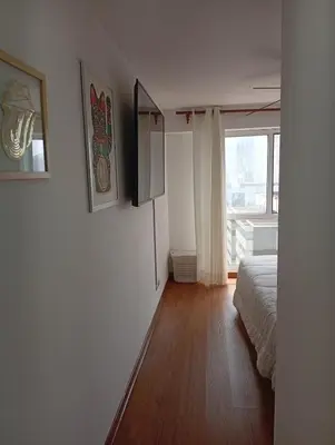 a white room with a bed and a window at Large Oceanview Balcony Apartment in Miraflores in Lima