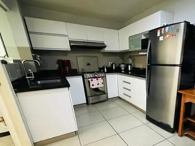 a kitchen with a refrigerator and a stove at Apartamento San Borja in Lima