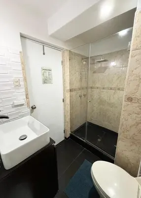 a bathroom with a toilet and a sink and a shower at Apartment with 3 bedrooms near the sea in Miraflores in Lima